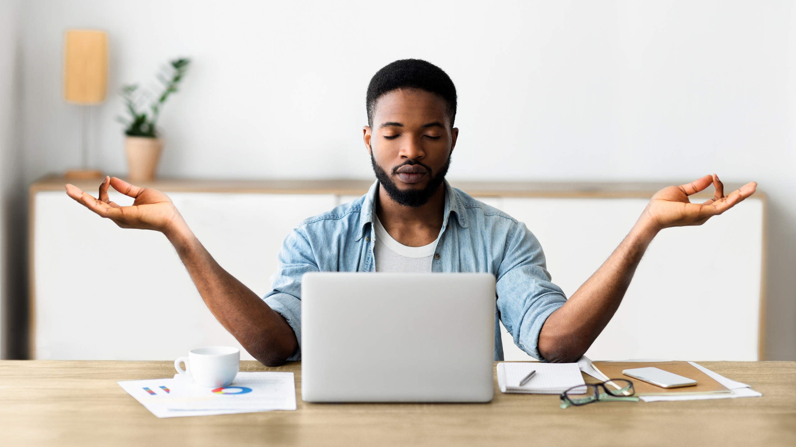 Relaxed,African,American,Businessman,Meditating,In,Office,,Practicing,Yoga,At